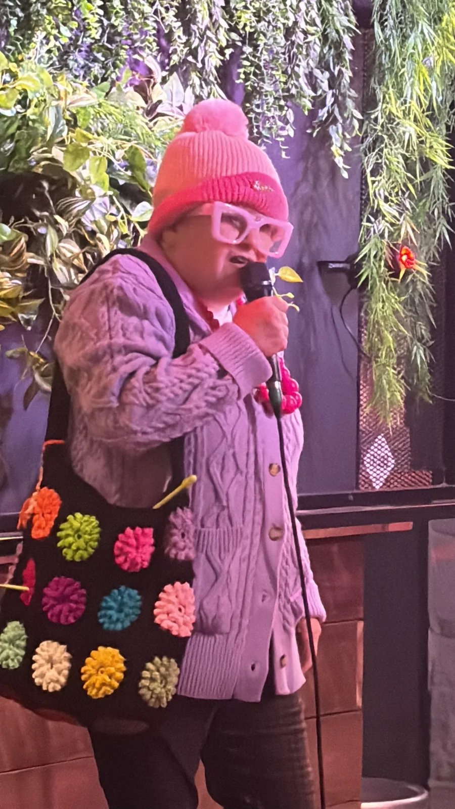 Grandma Poppsie pointing during a live comedy set
